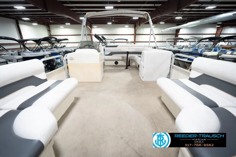 Slide: The Image of 2008 Misty Harbor 2085CR pontoon boat interior with white and gray seating in showroom. - 16