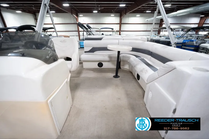 Slide: The Image of 2008 Misty Harbor 2085CR pontoon boat interior with seating and table in showroom. - 17