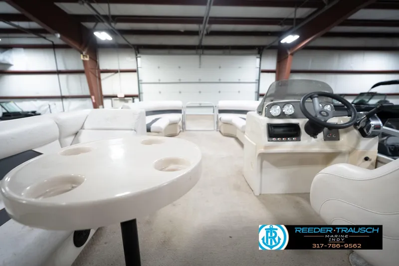Slide: The Image of 2008 Misty Harbor 2085CR pontoon boat interior with seating and steering console in a warehouse. - 19