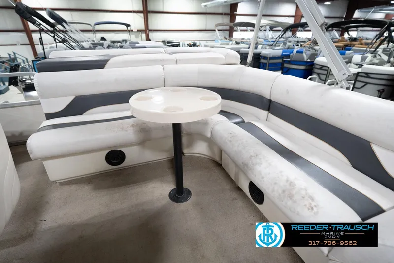 Slide: The Image of 2008 Misty Harbor 2085CR pontoon boat interior with seating and table in showroom. - 23