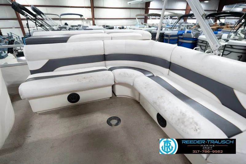 Slide: The Image of 2008 Misty Harbor 2085CR pontoon boat interior with white and gray seating in showroom. - 24