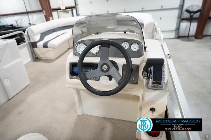 Slide: The Image of 2008 Misty Harbor 2085CR boat dashboard with steering wheel and control panel. - 26