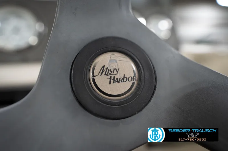 Slide: The Image of Steering wheel of 2008 Misty Harbor 2085CR boat with logo detail. - 28