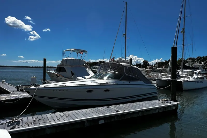 The Image of 1997 Formula 330 Sun Sport boat docked at marina under clear blue sky. - 0