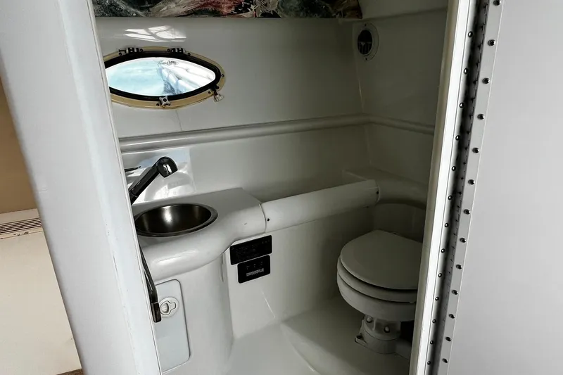 Slide: The Image of Interior of a 1997 Formula 330 Sun Sport boat with beige seating and portholes. - 21
