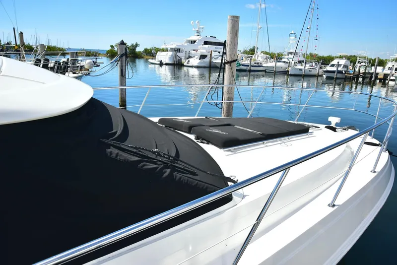 Slide: The Image of 2013 Sea Ray 410 Sundancer yacht docked at marina with clear blue sky. - 15