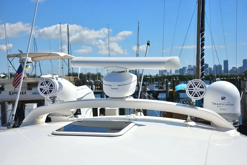 Slide: The Image of 2013 Sea Ray 410 Sundancer yacht with radar and speakers, docked at marina. - 29