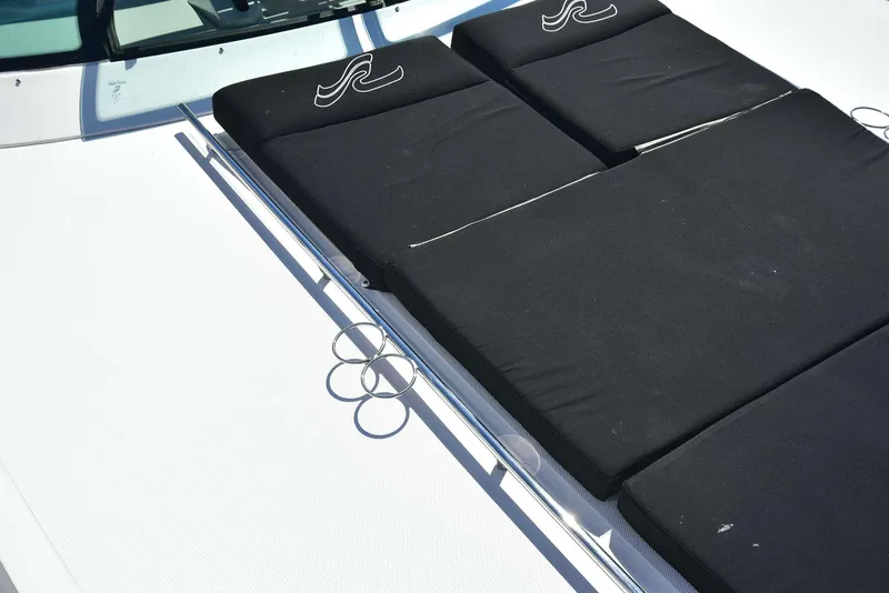 Slide: The Image of 2013 Sea Ray 410 Sundancer sunpad with black cushions on deck. - 30