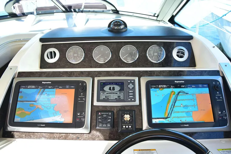 Slide: The Image of Dashboard of 2013 Sea Ray 410 Sundancer with navigation screens and gauges. - 34