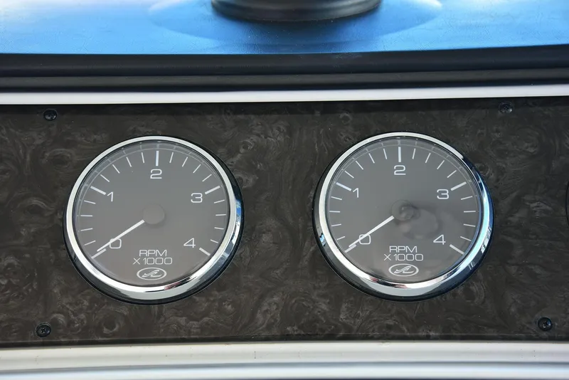 Slide: The Image of Dashboard gauges of a 2013 Sea Ray 410 Sundancer boat, showing RPM indicators. - 35
