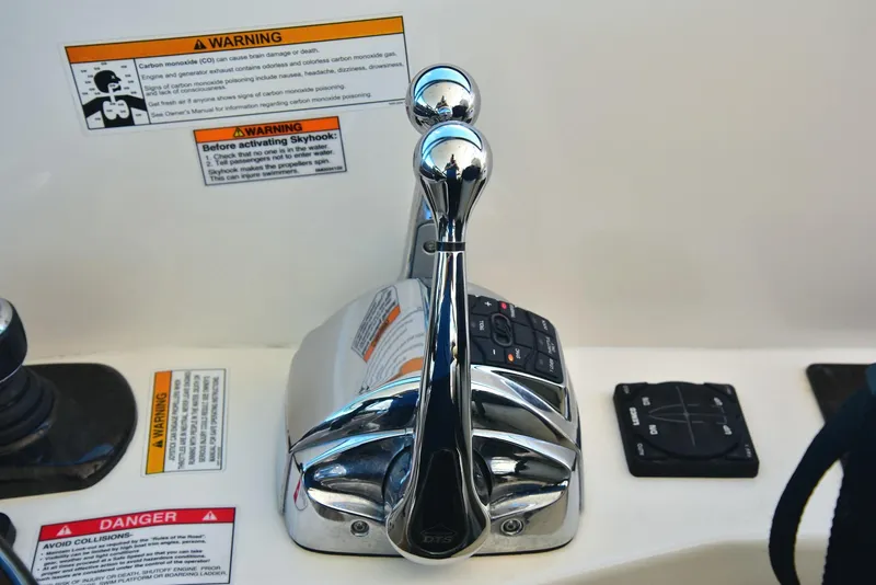 Slide: The Image of Control panel of a 2013 Sea Ray 410 Sundancer boat with warning labels. - 36