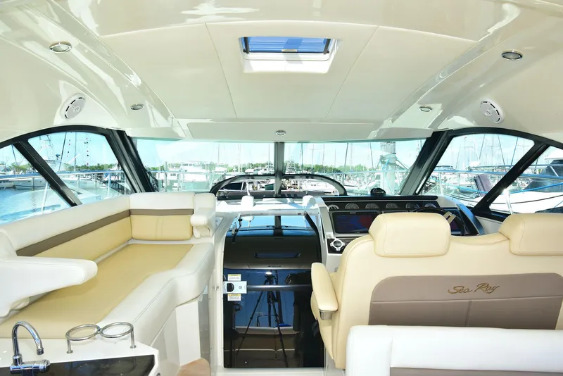 Slide: The Image of Interior of 2013 Sea Ray 410 Sundancer yacht with luxurious seating and helm. - 47