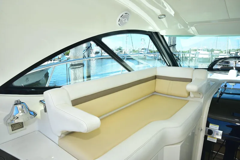 Slide: The Image of Luxurious interior seating on a 2013 Sea Ray 410 Sundancer yacht, docked at a marina. - 48