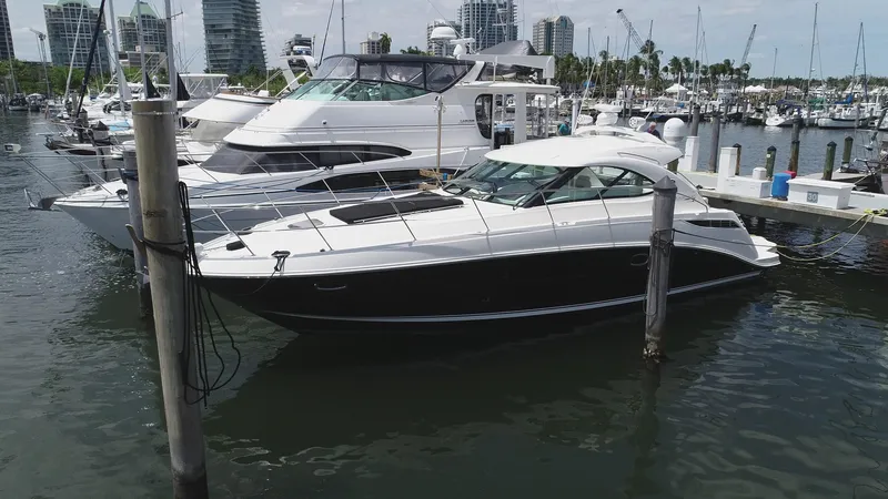 Slide: The Image of 2013 Sea Ray 410 Sundancer yacht docked in a marina with other boats. - 5