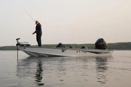 Slide: The Image of Manufacturer Provided Image: 2021 Lund 2075 Pro-V Bass boat on calm lake with angler fishing. - 15