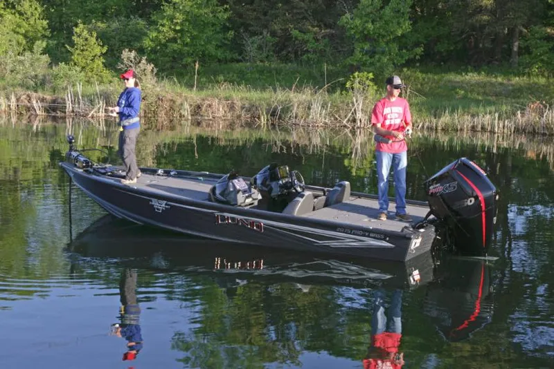 Slide: The Image of Manufacturer Provided Image: 2021 Lund 2075 Pro-V Bass boat on a calm lake with two anglers fishing. - 16