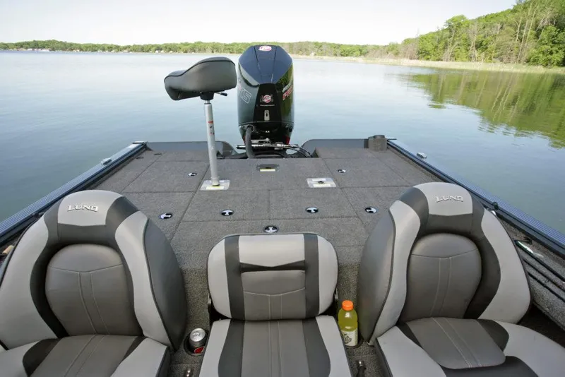 Slide: The Image of Manufacturer Provided Image: 2021 Lund 2075 Pro-V Bass boat interior with seats and motor on a calm lake. - 21