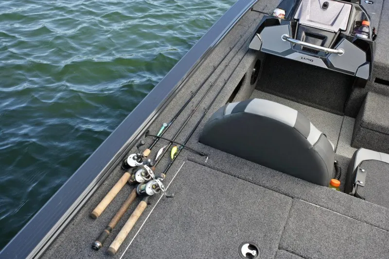 Slide: The Image of Manufacturer Provided Image: 2021 Lund 2075 Pro-V Bass boat interior with fishing rods on deck. - 22