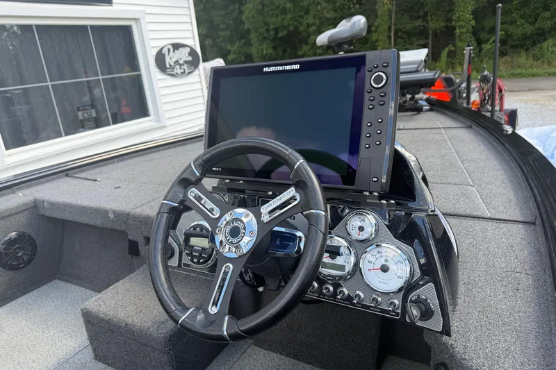 Slide: The Image of 2021 Lund 2075 Pro-V Bass boat dashboard with steering wheel and Humminbird electronics. - 4