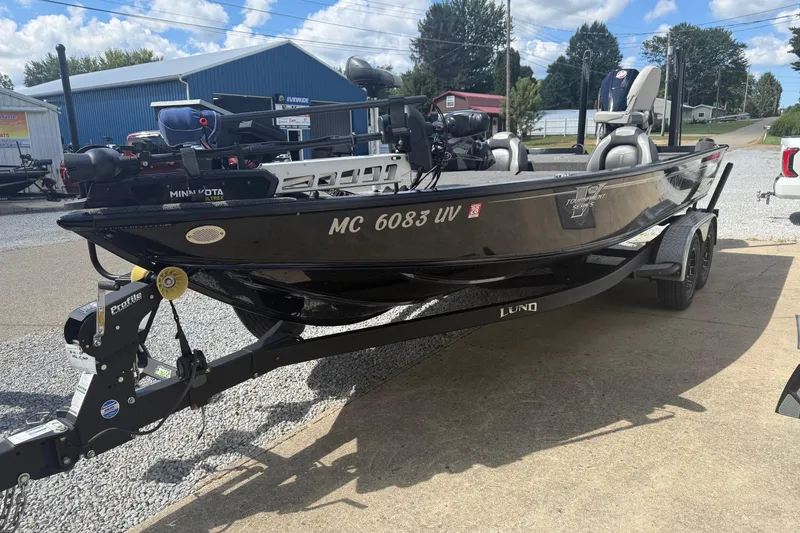 Slide: The Image of 2021 Lund 2075 Pro-V Bass boat on trailer, parked outdoors under blue sky. - 8