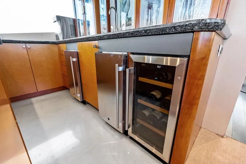 Slide: The Image of Luxurious 2006 Lazzara Skylounge yacht kitchen with modern appliances and wine cooler. - 25