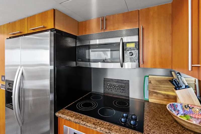 Slide: The Image of Modern kitchen in 2006 Lazzara Skylounge yacht with stainless steel appliances and wooden cabinetry. - 31