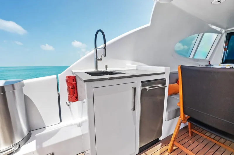 Slide: The Image of 2006 Lazzara Skylounge yacht deck with kitchenette, ocean view, and seating area. - 37