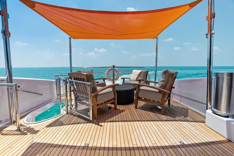 Slide: The Image of Luxurious 2006 Lazzara Skylounge yacht deck with seating, ocean view, and orange canopy. - 38