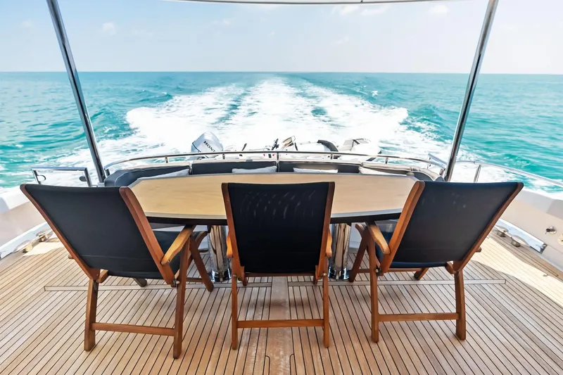 Slide: The Image of Luxury yacht deck with chairs and table, Lazzara Skylounge 2006, cruising on open sea. - 40