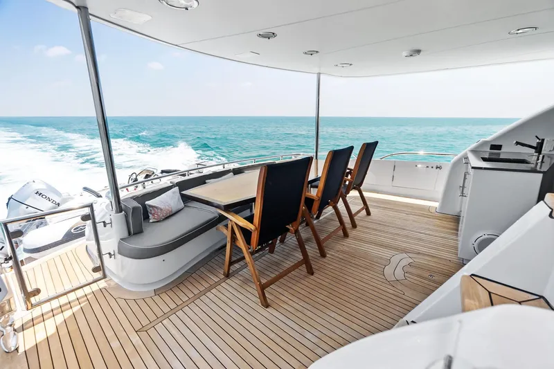 Slide: The Image of Luxurious 2006 Lazzara Skylounge yacht deck with seating, ocean view, and teak flooring. - 41