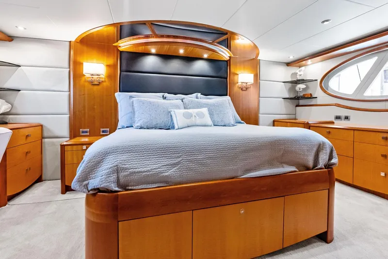Slide: The Image of Luxurious 2006 Lazzara Skylounge yacht bedroom with elegant wood furnishings and modern design. - 48