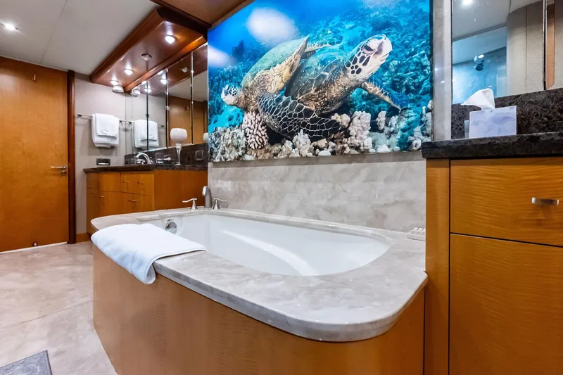 Slide: The Image of Luxurious bathroom in 2006 Lazzara Skylounge yacht with turtle artwork above bathtub. - 54