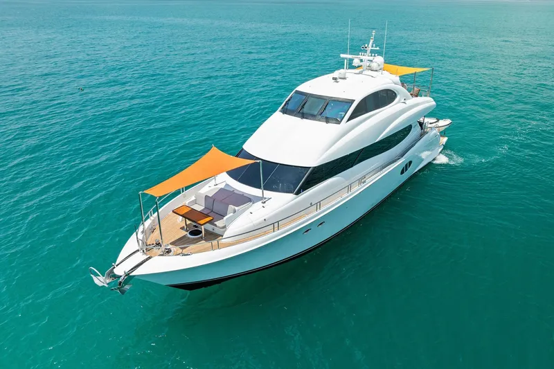 Slide: The Image of Luxurious 2006 Lazzara Skylounge yacht cruising on clear blue waters. - 8