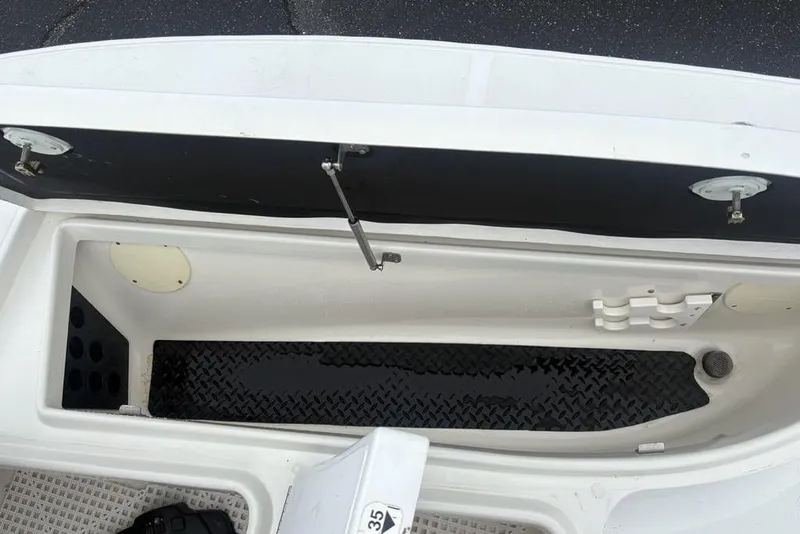 Slide: The Image of Open storage compartment on a 2003 Ranger 2300 Bay Ranger boat, showing interior details. - 13