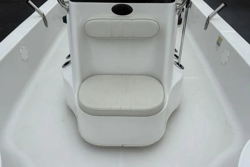 Slide: The Image of 2003 Ranger 2300 Bay Ranger boat interior with white seating and console. - 14