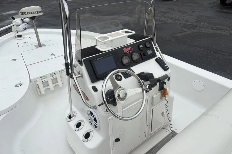 Slide: The Image of 2003 Ranger 2300 Bay Ranger boat console with steering wheel and navigation controls. - 16