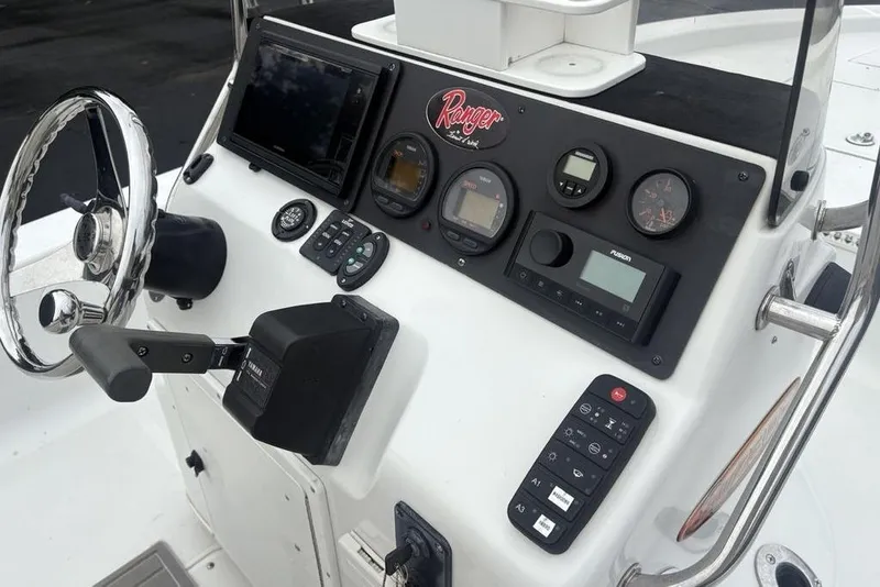 Slide: The Image of 2003 Ranger 2300 Bay Ranger boat dashboard with steering wheel and control panel. - 17