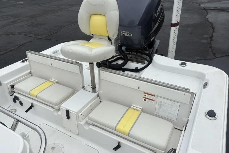 Slide: The Image of 2003 Ranger 2300 Bay Ranger boat interior with Yamaha 250 engine and cushioned seating. - 24