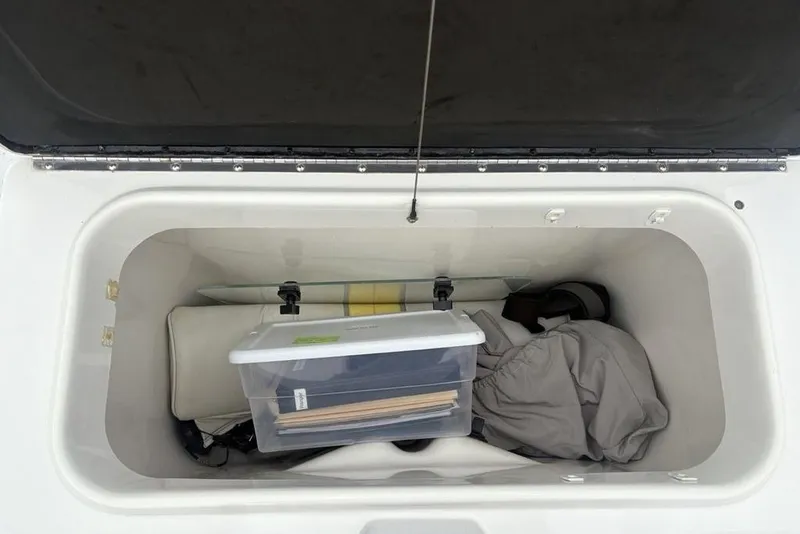 Slide: The Image of Storage compartment of 2003 Ranger 2300 Bay Ranger boat with gear and container. - 28