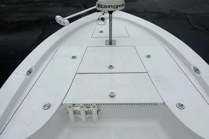 Slide: The Image of 2003 Ranger 2300 Bay Ranger boat deck with storage compartments and rod holders. - 8