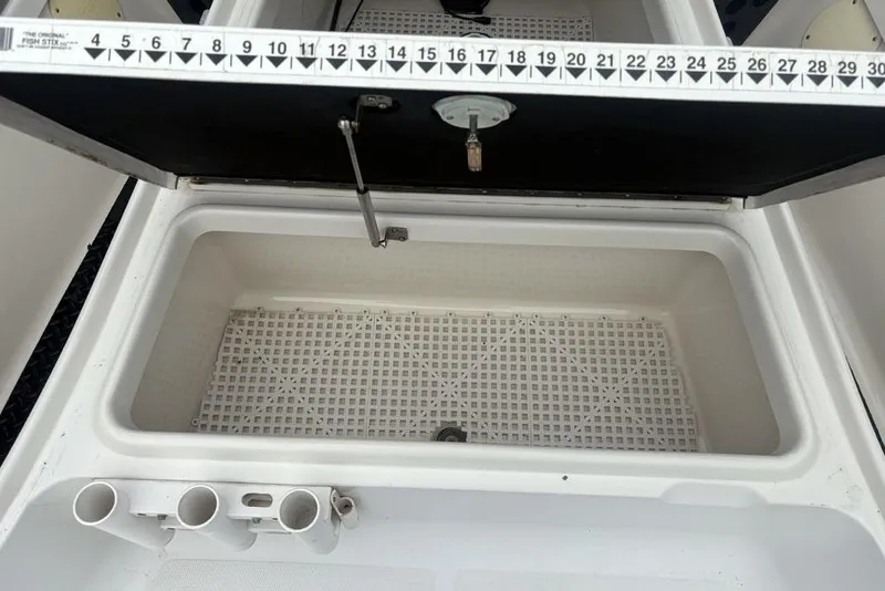 Slide: The Image of Open storage compartment on 2003 Ranger 2300 Bay Ranger boat with measuring scale. - 9