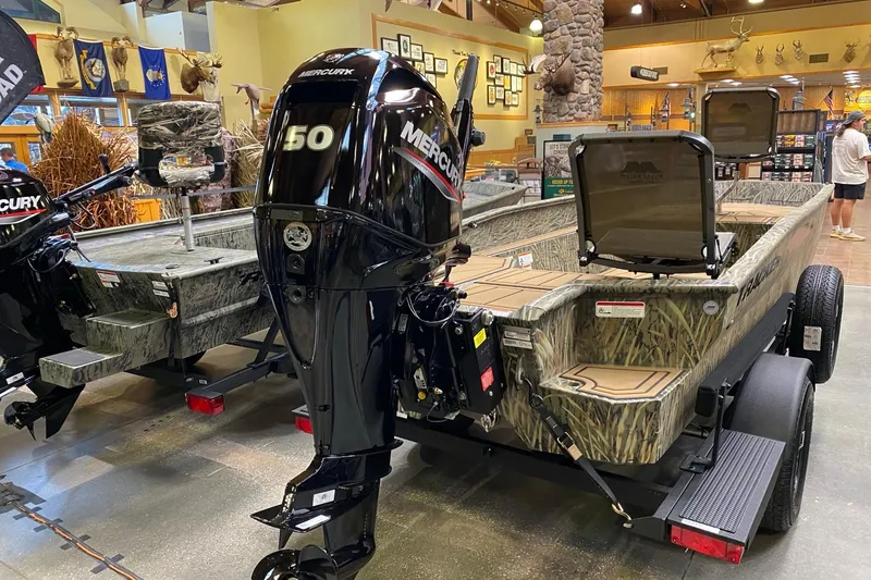 Slide: The Image of 2026 Tracker Grizzly 1650 T Prairie Wings Edition boat with Mercury 150 engine in showroom. - 2