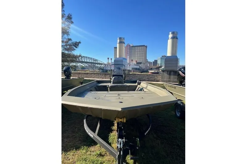 Slide: The Image of 2026 Tracker Grizzly 2072 CC boat displayed outdoors with cityscape background. - 37