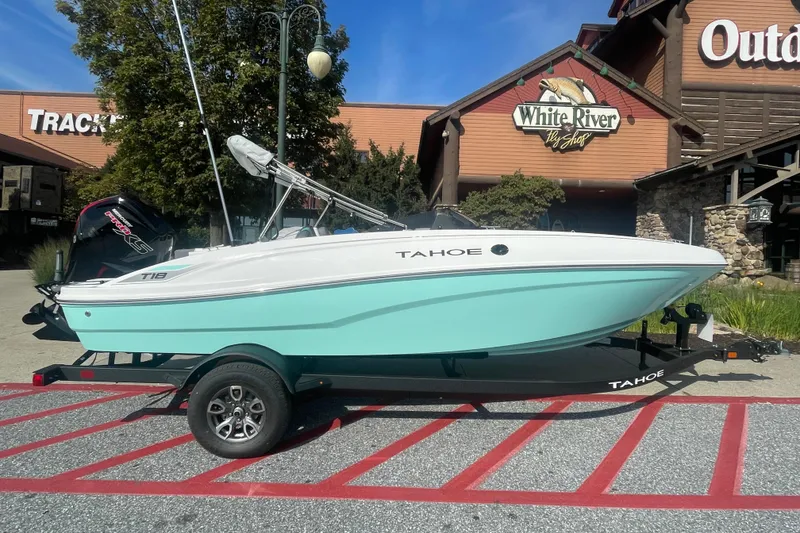 The Image of 2026 Tahoe T18 boat on trailer, parked outside White River Outpost, with "We Take Trades" sign. - 0