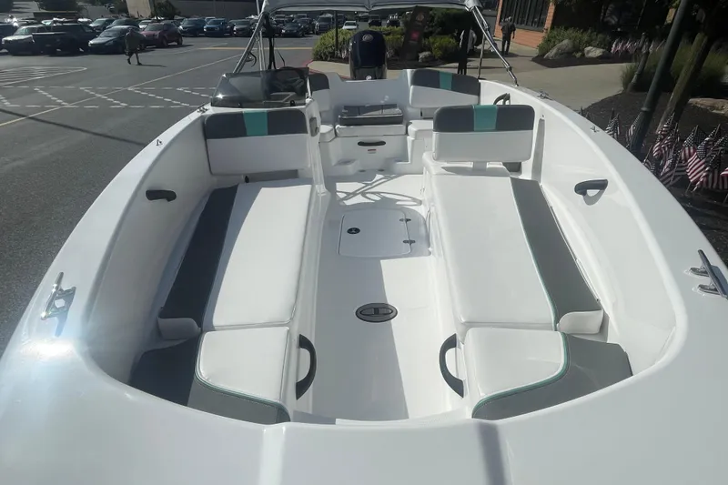 Slide: The Image of 2026 Tahoe T18 boat with Mercury Pro XS engine at outdoor store entrance. - 2