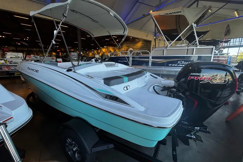 Slide: The Image of 2026 Tahoe T18 boat with Mercury Pro XS engine displayed indoors. - 1