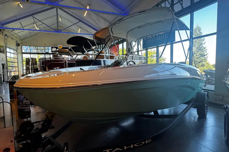Slide: The Image of 2026 Tahoe T18 boat displayed in a showroom with modern lighting. - 2