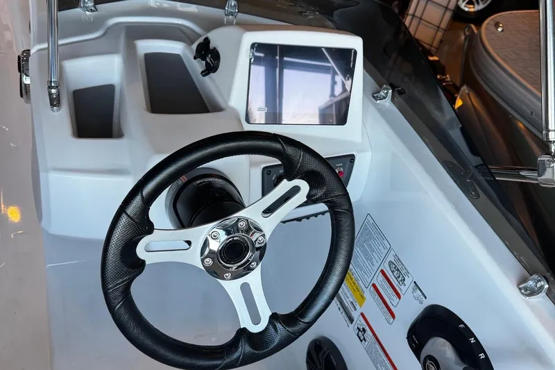 Slide: The Image of 2026 Tahoe T18 boat dashboard with steering wheel and digital display. - 3