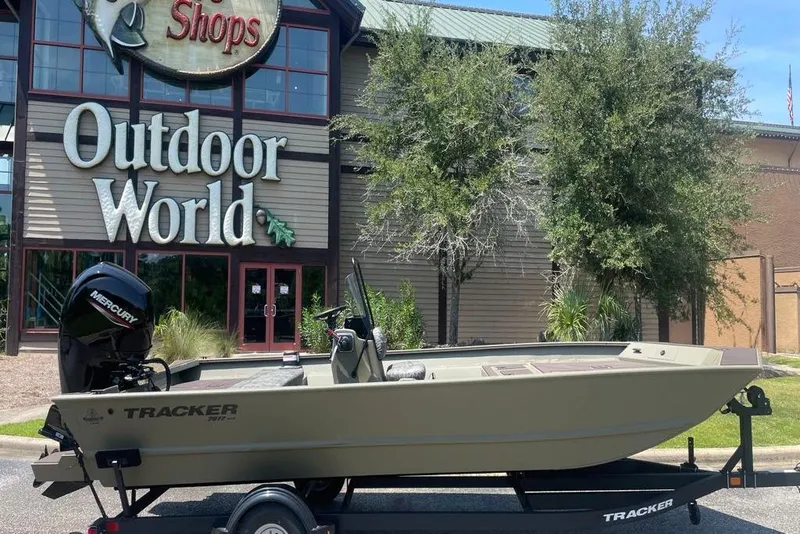 Slide: The Image of 2026 Tracker Grizzly 2072 CC boat outside Outdoor World store. - 2