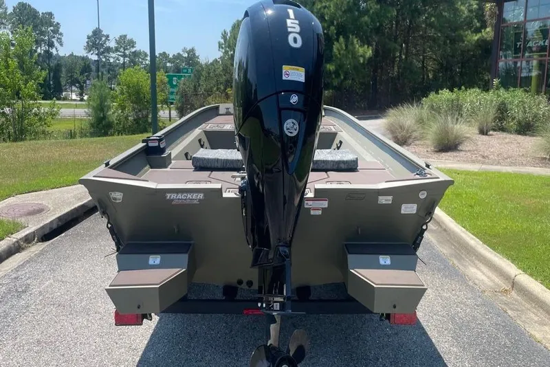 Slide: The Image of 2026 Tracker Grizzly 2072 CC boat with 150 HP engine, parked outdoors. - 3